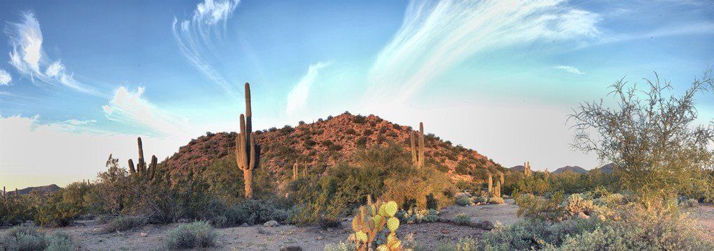 Tucson sunset mural with swirling clouds and mountain, perfect for indoor and outdoor spaces.