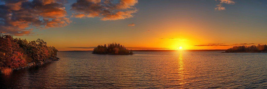 Panoramic sunset mural of Swedish Archipelago, ideal for serene indoor and outdoor spaces.