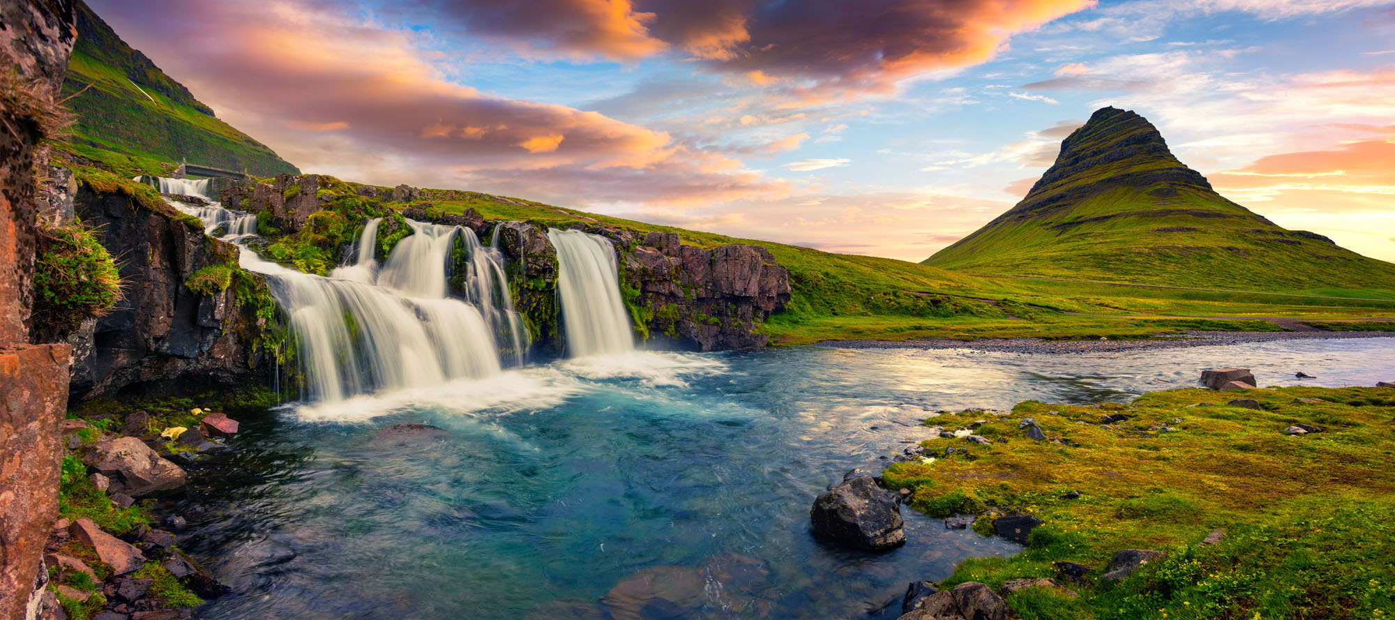 Panoramic sunset mural of Kirkjufellsfoss and Kirkjufell mountain, ideal for indoor and outdoor spaces.